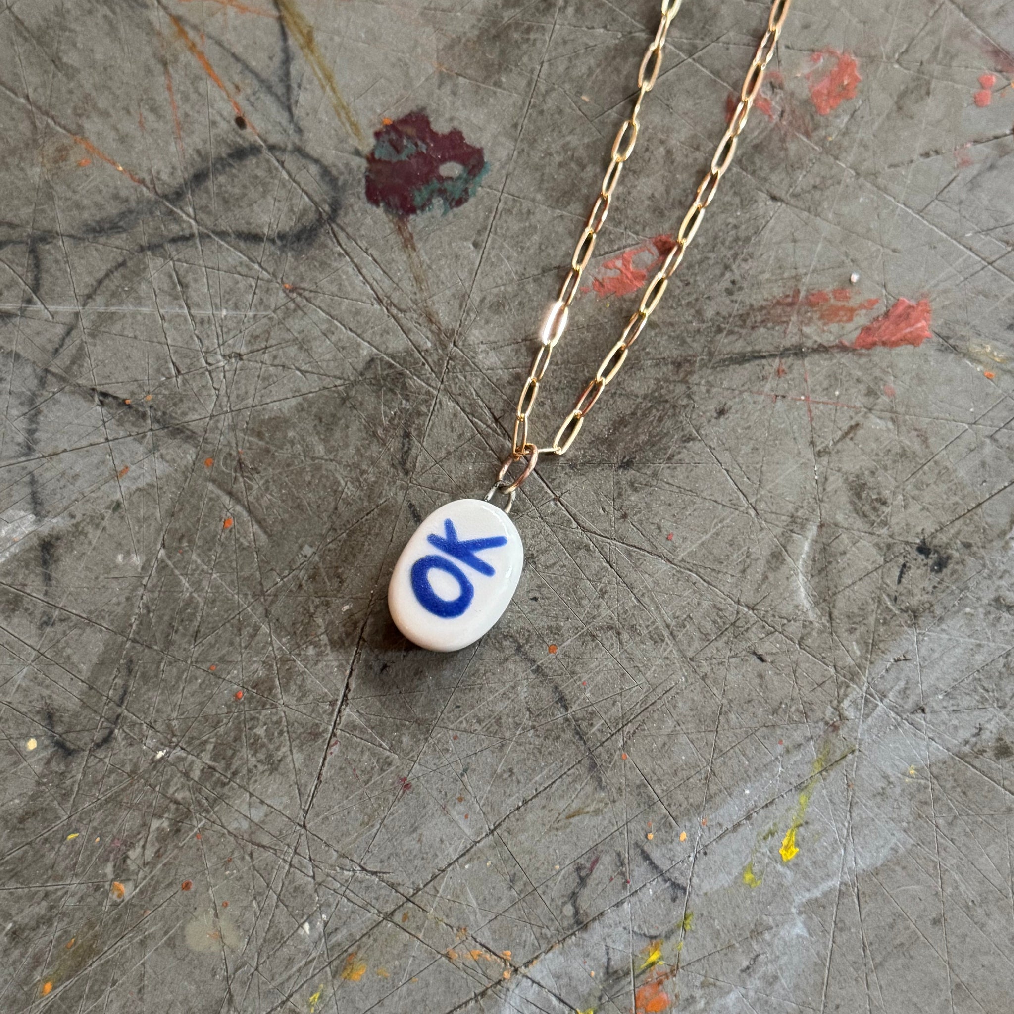 White Porcelain OK Bye Pendant Necklace in 18" Gold Paperclip Chain